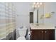Clean bathroom featuring a toilet, vanity, mirror, and a striped shower curtain at 755 Ivy Ln, Carmel, IN 46032