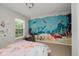 Bedroom with mural, comfortable furniture, natural light, and cozy decor at 755 Ivy Ln, Carmel, IN 46032
