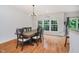 Bright dining area with hardwood floors, modern chandelier, and large windows at 755 Ivy Ln, Carmel, IN 46032