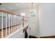 Bright entryway with hardwood floors, coat rack, chandelier, and staircase at 755 Ivy Ln, Carmel, IN 46032