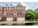Brick townhouse with gray shutters, attached garage, and manicured lawn at 755 Ivy Ln, Carmel, IN 46032