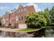 Brick townhouse with green shutters, attached garage, and manicured lawn at 755 Ivy Ln, Carmel, IN 46032