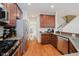 Modern kitchen with stainless steel appliances, granite countertops, and hardwood floors at 755 Ivy Ln, Carmel, IN 46032