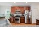 Bright kitchen features stainless steel appliances, granite counters, and wood floors at 755 Ivy Ln, Carmel, IN 46032
