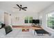 Cozy living room featuring hardwood floors, bright windows, and ceiling fan at 755 Ivy Ln, Carmel, IN 46032