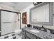 This full bathroom features a standing shower and granite countertops at 8133 Lower Bay Ln, Indianapolis, IN 46236