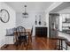 Cozy dining nook with wood floors, built-in bench seating, decorative lighting, and stainless steel fridge at 8133 Lower Bay Ln, Indianapolis, IN 46236
