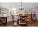 An elegant dining room with glass table, chandelier, and views of the outdoors, perfect for gatherings at 8133 Lower Bay Ln, Indianapolis, IN 46236