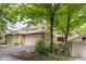 An inviting townhome boasting a stone facade, two-car garage, and well-maintained landscaping at 8133 Lower Bay Ln, Indianapolis, IN 46236