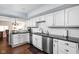Bright kitchen with white cabinets, granite countertops, stainless steel appliances and a view into the dining room at 8133 Lower Bay Ln, Indianapolis, IN 46236
