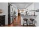 Updated kitchen with a view to dining, features stainless steel appliances, granite counters, and white cabinetry at 8133 Lower Bay Ln, Indianapolis, IN 46236