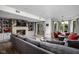 Basement living space with fireplace, built-ins, gray sectional, walkout to the backyard, and natural light at 8133 Lower Bay Ln, Indianapolis, IN 46236