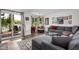 Open living area with access to outdoor deck, lake views, and comfortable seating at 8133 Lower Bay Ln, Indianapolis, IN 46236