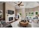 Open-concept living room with fireplace and views of lake, offering a bright and airy space at 8133 Lower Bay Ln, Indianapolis, IN 46236
