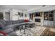 Basement living area with stone fireplace, large sectional sofa, built-in shelves, and a wet bar at 8133 Lower Bay Ln, Indianapolis, IN 46236