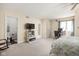 This main bedroom offers a ceiling fan, en-suite bathroom, a workspace and neutral tones at 8133 Lower Bay Ln, Indianapolis, IN 46236