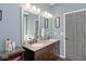 Bathroom featuring double sinks, a granite countertop, and framed mirrors for a modern touch at 8176 Crumwell Dr, Avon, IN 46123