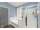Well-lit bathroom featuring a shower, tub, and a door leading to another part of the house at 8176 Crumwell Dr, Avon, IN 46123