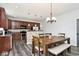 Open dining area with wood table set, chandelier and view to the kitchen at 8176 Crumwell Dr, Avon, IN 46123
