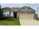 Charming home featuring a brick facade, tan siding, and a two-car garage at 8176 Crumwell Dr, Avon, IN 46123
