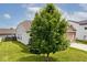 A large tree gives shade to this home's side yard, adding an element of privacy and beauty at 8176 Crumwell Dr, Avon, IN 46123