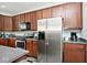 Kitchen area featuring stainless appliances, wood cabinetry, and sleek countertops at 8176 Crumwell Dr, Avon, IN 46123