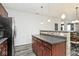 Kitchen featuring wood cabinets, gray counters, and a breakfast bar area at 8176 Crumwell Dr, Avon, IN 46123