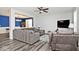 Living room with gray furniture and view into bonus room with blue accent wall at 8176 Crumwell Dr, Avon, IN 46123