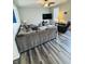 Inviting living room features gray wood floors, a plush sectional sofa, and a large-screen TV for entertainment at 8176 Crumwell Dr, Avon, IN 46123