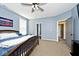 Comfortable main bedroom with blue walls, a ceiling fan, and ensuite bathroom access at 8176 Crumwell Dr, Avon, IN 46123