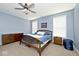 Bright main bedroom with a full bed, ceiling fan, and multiple windows for natural light at 8176 Crumwell Dr, Avon, IN 46123