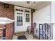 Back porch with white walls, brick accents and two chairs at 8436 E 56Th St, Indianapolis, IN 46216