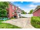 Backyard with brick house, green grass, white fence, and a patio with toys at 8436 E 56Th St, Indianapolis, IN 46216