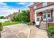The backyard features a brick home, green grass, white trim and a patio with toys at 8436 E 56Th St, Indianapolis, IN 46216
