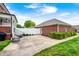 Backyard with a brick home, green grass, patio, white fence, and a detached garage at 8436 E 56Th St, Indianapolis, IN 46216
