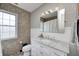 Bathroom featuring tiled walls, large mirror with vanity lights, and white cabinets at 8436 E 56Th St, Indianapolis, IN 46216