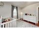 Well-lit Bedroom with hardwood floors, neutral walls, and a white crib at 8436 E 56Th St, Indianapolis, IN 46216