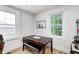 Bright dining area boasts natural light and wooden floors, with a dark wood table and bench at 8436 E 56Th St, Indianapolis, IN 46216