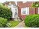 Charming brick home featuring a covered front entrance and manicured landscaping at 8436 E 56Th St, Indianapolis, IN 46216