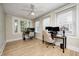 Dedicated home office space with two workstations, hardwood floors, and a ceiling fan at 8436 E 56Th St, Indianapolis, IN 46216