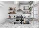 Kitchen features floating shelves, stainless steel oven, granite countertops, and tile backsplash at 8436 E 56Th St, Indianapolis, IN 46216