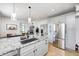 Updated kitchen features a granite island with sink, stainless steel appliances, and sleek cabinetry at 8436 E 56Th St, Indianapolis, IN 46216