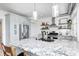 Modern kitchen boasts a large granite island, stainless steel appliances, and stylish pendant lighting fixtures at 8436 E 56Th St, Indianapolis, IN 46216
