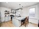 Charming kitchen features a large island with granite countertops, stainless steel appliances, and sleek white cabinetry at 8436 E 56Th St, Indianapolis, IN 46216