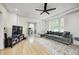 Bright living room featuring hardwood floors, a ceiling fan, and ample natural light at 8436 E 56Th St, Indianapolis, IN 46216