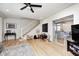 Open-concept living area with hardwood floors, view to kitchen, and a comfortable seating arrangement at 8436 E 56Th St, Indianapolis, IN 46216