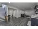 Finished basement area with vinyl floors, neutral paint, a gray couch, and a staircase with baby gate at 8695 Morgan Dr, Fishers, IN 46038