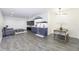 Finished basement featuring gray vinyl floors, a living area with a TV, and a bar with small dining area at 8695 Morgan Dr, Fishers, IN 46038