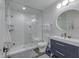 Bathroom featuring a walk-in shower, tile floors, modern vanity, and a round mirror with integrated lighting at 8695 Morgan Dr, Fishers, IN 46038