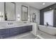 Modern bathroom featuring double vanities, a soaking tub, a glass-enclosed shower, and sleek fixtures at 8695 Morgan Dr, Fishers, IN 46038
